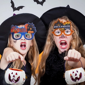 Children wearing felt Halloween party glasses with pumpkin, castle and bat decorations