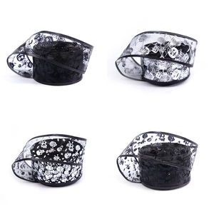 Detailed view of Halloween organza ribbons with silver skull, pumpkin and web prints