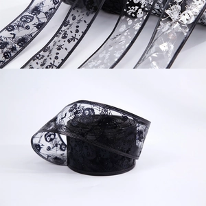 Detail view of Halloween themed sheer mesh ribbons with pumpkin and spider web gold stamping