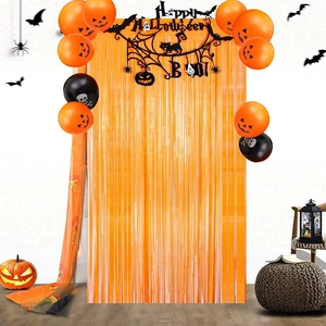 Halloween party set with orange fringe curtain, pumpkin balloons and Happy Halloween banner