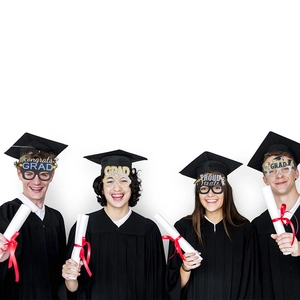 Smiling graduates wearing assorted glittery graduation party glasses and caps in a group photo
