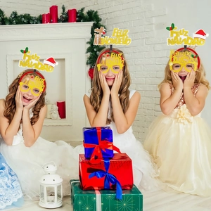 Three girls wearing gold glitter Feliz Navidad headbands and festive glasses at a party