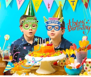 Kids happy birthday party glasses with funny green frog and blue party hat designs