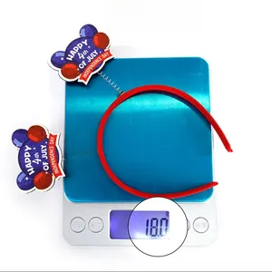 Close-up of Independence Day headband with sequin balloon decor on a weighing scale