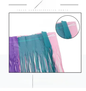 Macro detail of tricolor fringe curtain with adhesive backing in purple blue and pink