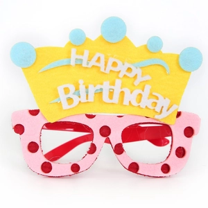 Detail of pink felt birthday party glasses with yellow crown and HAPPY Birthday lettering