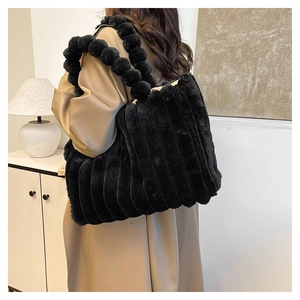 Detail of black faux fur tote bag with plush handle and soft vertical texture