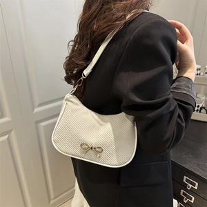 French retro cream woven underarm bag with elegant gold bow metal buckle and thin strap