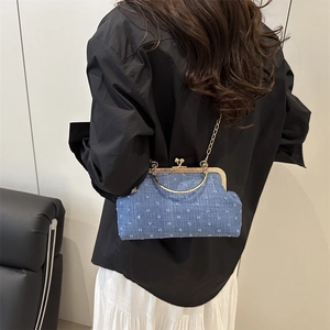Blue denim jacquard crossbody bag with vintage gold chain and clasp shown on model