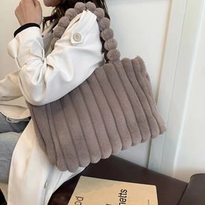 Large plush tote bag with ribbed texture and unique puff handle for autumn style