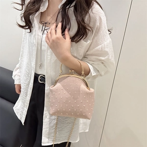 Pink textured shell crossbody bag with gold chain strap and metal handle for women