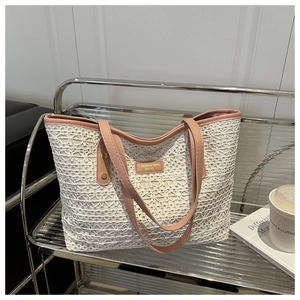 Close-up of white floral lace texture and pink leather trim on large tote bag