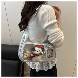 Detail of silver ita bag featuring a clear window and side bow on a shoulder strap