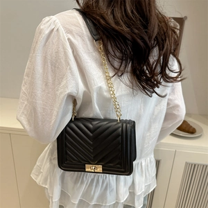 Chic black chevron quilted shoulder bag with gold chain and metal lock closure