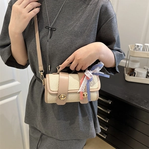 Minimalist beige woven pillow bag with decorative bow and pink leather trim for women