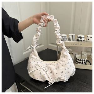 Detail of floral shoulder bag with ruched handle and sweet blue flower pattern