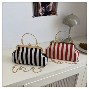 Close-up of retro striped woven bags with gold metal frame and ball clasp detail