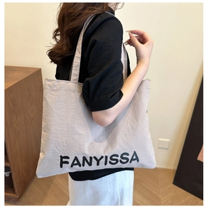 Close-up of a large grey nylon tote bag with black FANYISSA text lettering for women