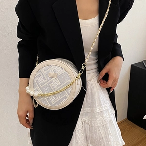 Chic round crossbody bag in beige with geometric maze pattern and pearl chain details
