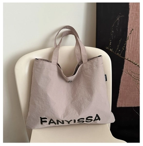 Detail view of the FANYISSA tote bag interior showing the magnetic clasp and nylon texture