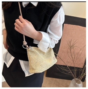 Detail of summer straw shoulder bag with natural woven texture and zipper closure