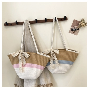 Detail of handmade woven bucket bags featuring lace bows and color-block design