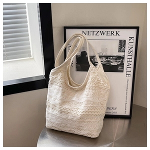 Close-up of intricate floral lace texture on white summer tote bag with soft natural shadows