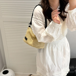 Straw woven shoulder bag with black leather strap for summer casual minimalist look