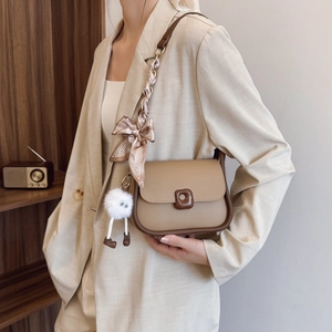 Stylish khaki crossbody bag with silk scarf strap and plush charm for women