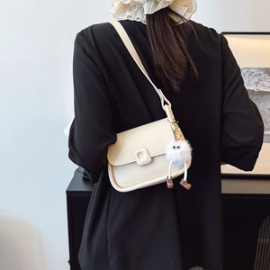 Minimalist beige crossbody box bag for women with cute white plush monster charm