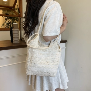 Minimalist white lace crochet shoulder bag for women shown in a cozy cafe setting