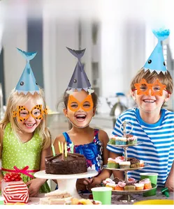 Kids wearing shark and sea creature themed paper party glasses and hats at a birthday party