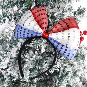 Detail of USA Independence Day headband with red, white, and blue sequins on a snowy branch