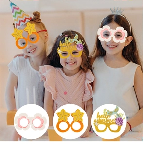 Close-up of three Hawaiian themed kids party glasses with starfish and mermaid tail designs