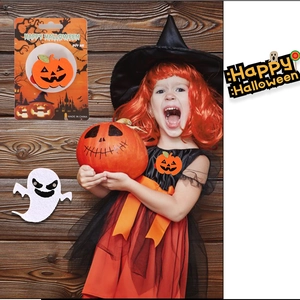 Detail of felt pumpkin and ghost badges worn by a girl in a festive Halloween outfit