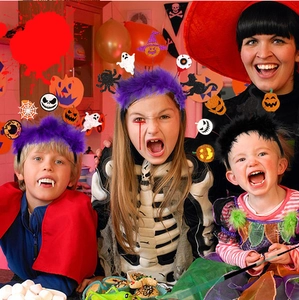 Group of children wearing Halloween feather headbands with ghost and pumpkin decorations