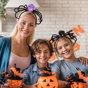 Family wearing plush spider headbands and mini Halloween pumpkin hats for party props