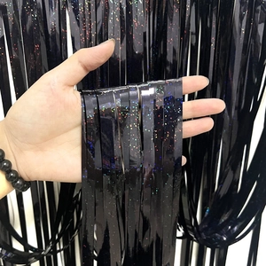 Close-up of black holographic fringe curtain strips with colorful glitter for party decor