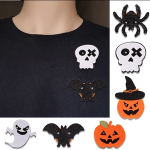 Detailed view of LED Halloween pins including glowing pumpkin, bat, and ghost felt badges