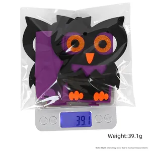 Detail shot of a purple Halloween owl felt bag on a scale showing 39.1g weight