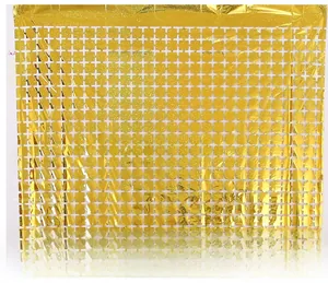 Detail of golden laser square tinsel curtain with shimmering metallic grid pattern