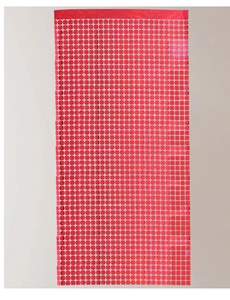 Detail of red hollowed-out square grid tinsel curtain for party background decoration