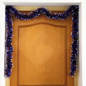 Patriotic Independence Day tinsel garland with red blue and silver stars on wood door