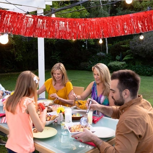 Macro shot of metallic red foil fringe curtain used for festive party background decoration