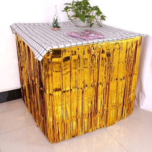 Close-up of shiny gold foil fringe table skirt for festive party decoration