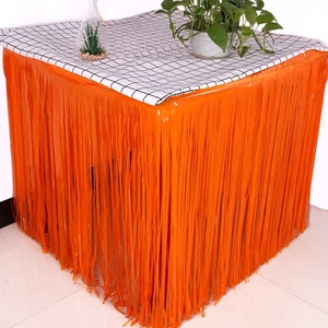 Close-up of bright orange metallic foil fringe table skirt for party decorations