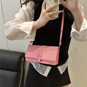 Pink minimalist crossbody square bag with flap closure and adjustable shoulder strap