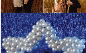 Detail view of blue and gold tinsel curtains with matching party balloons