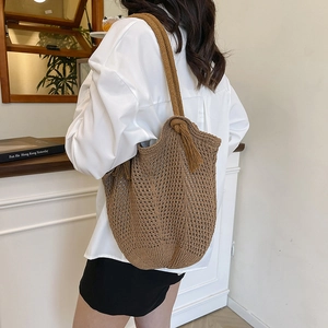 Brown knit tote bag with shoulder straps, retro hollow design for women in casual settings