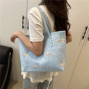Stylish light blue quilted tote bag with colorful butterfly embroidery and large capacity